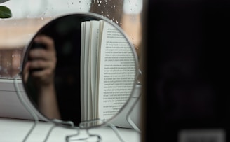woman in white and black stripe shirt holding book