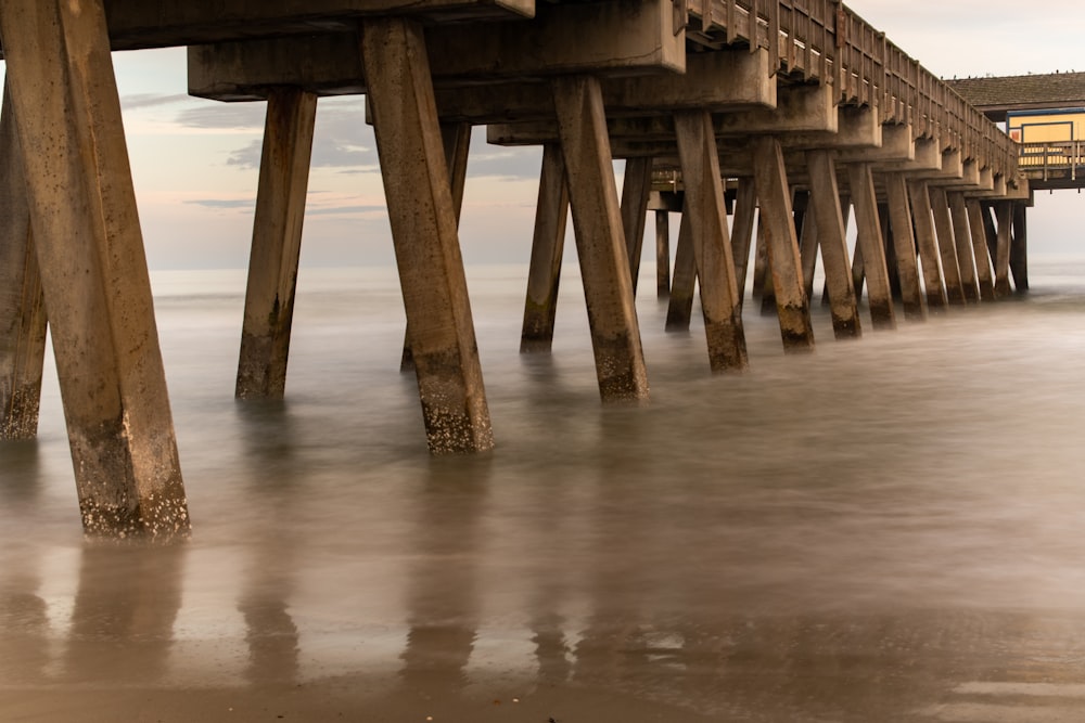 brown wooden dock on body of water during daytime