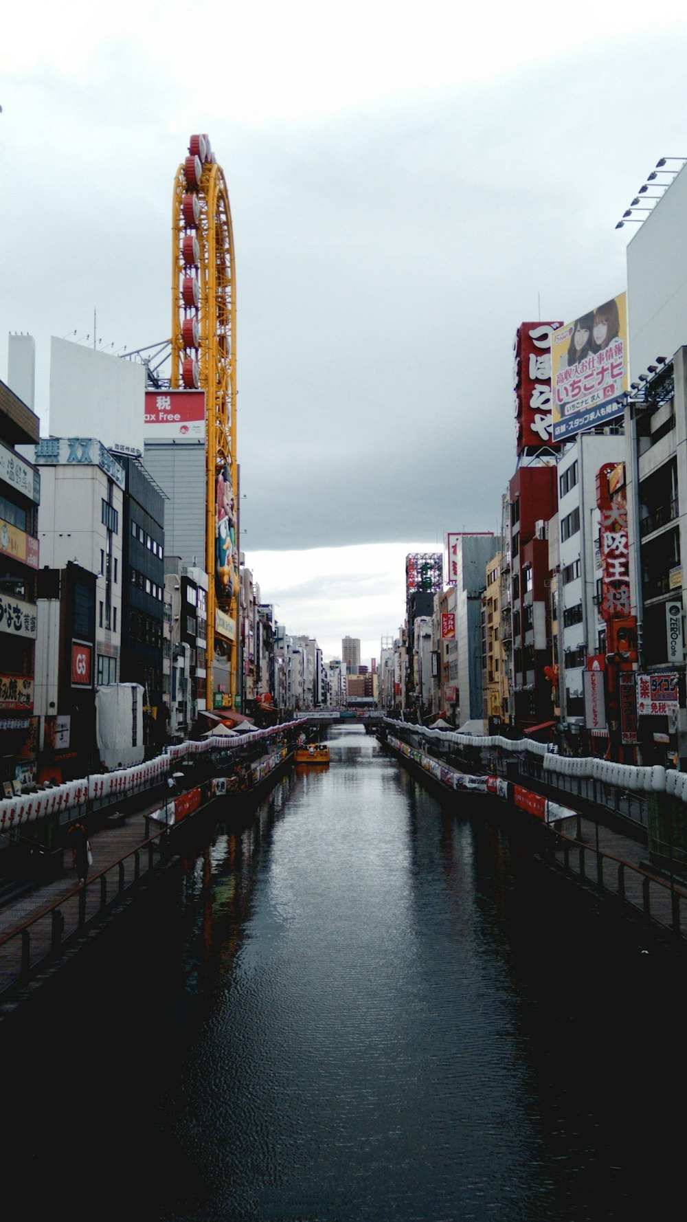 river between high rise buildings during daytime