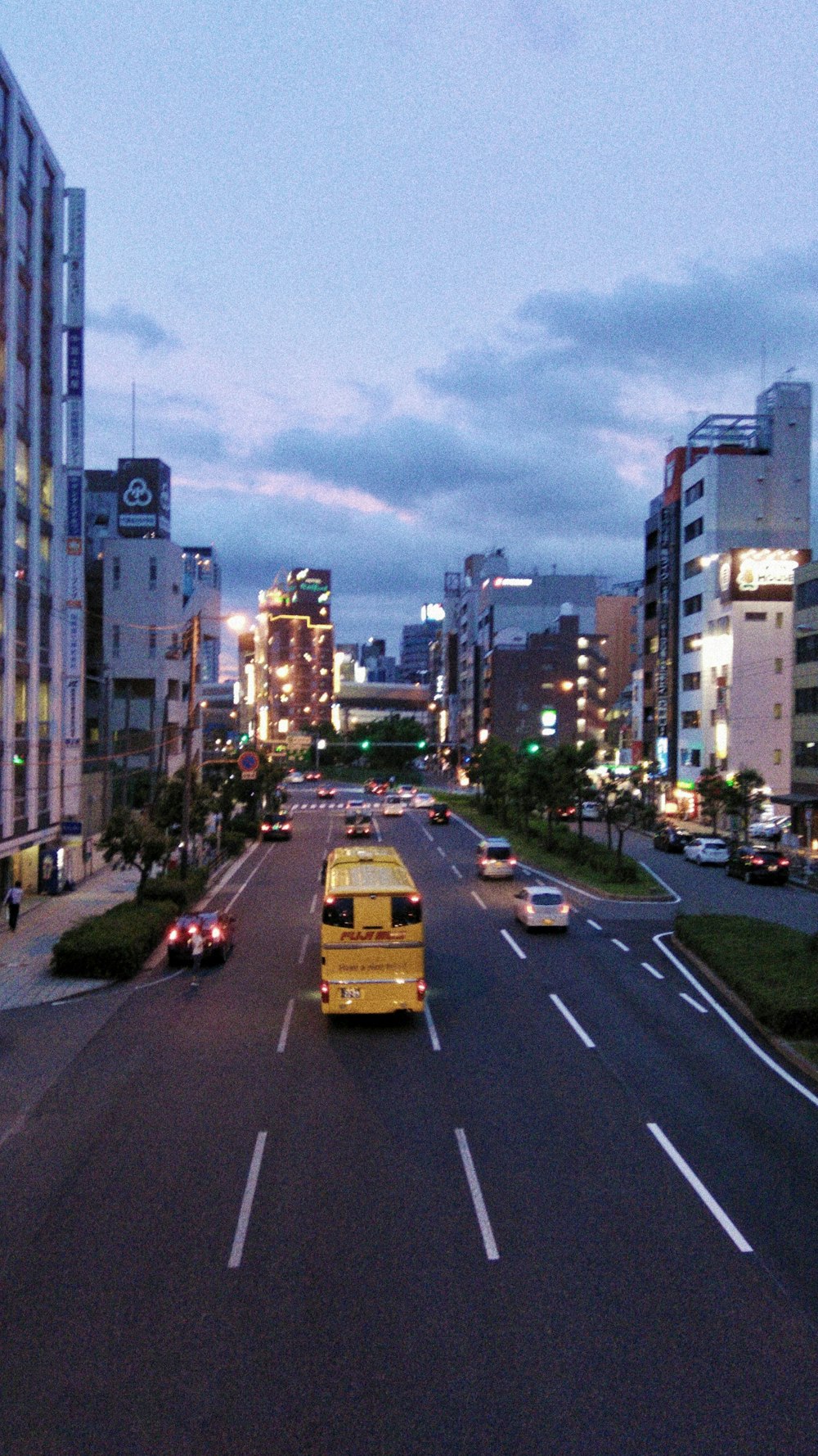 cars on road near high rise buildings during daytime