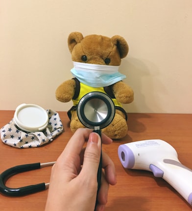 brown bear plush toy beside white and black round frame