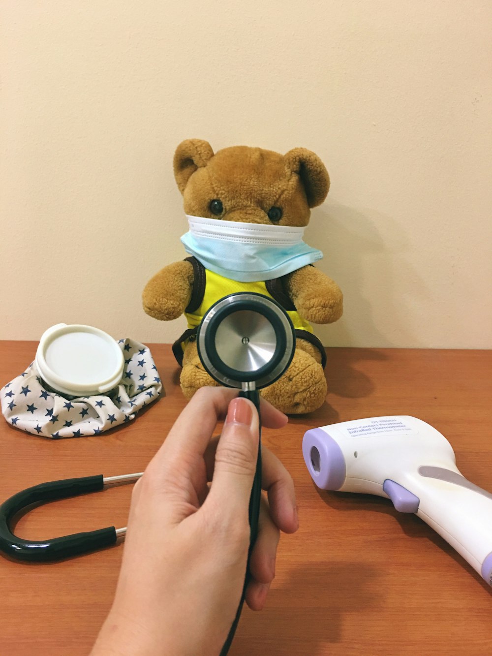 brown bear plush toy beside white and black round frame