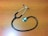 A stethoscope with dark tubing and a metal chest piece is placed on a wooden surface.