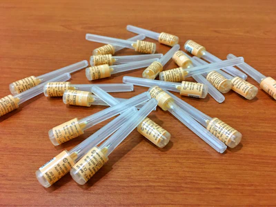 Set of peptide powder samples in small containers with labels.