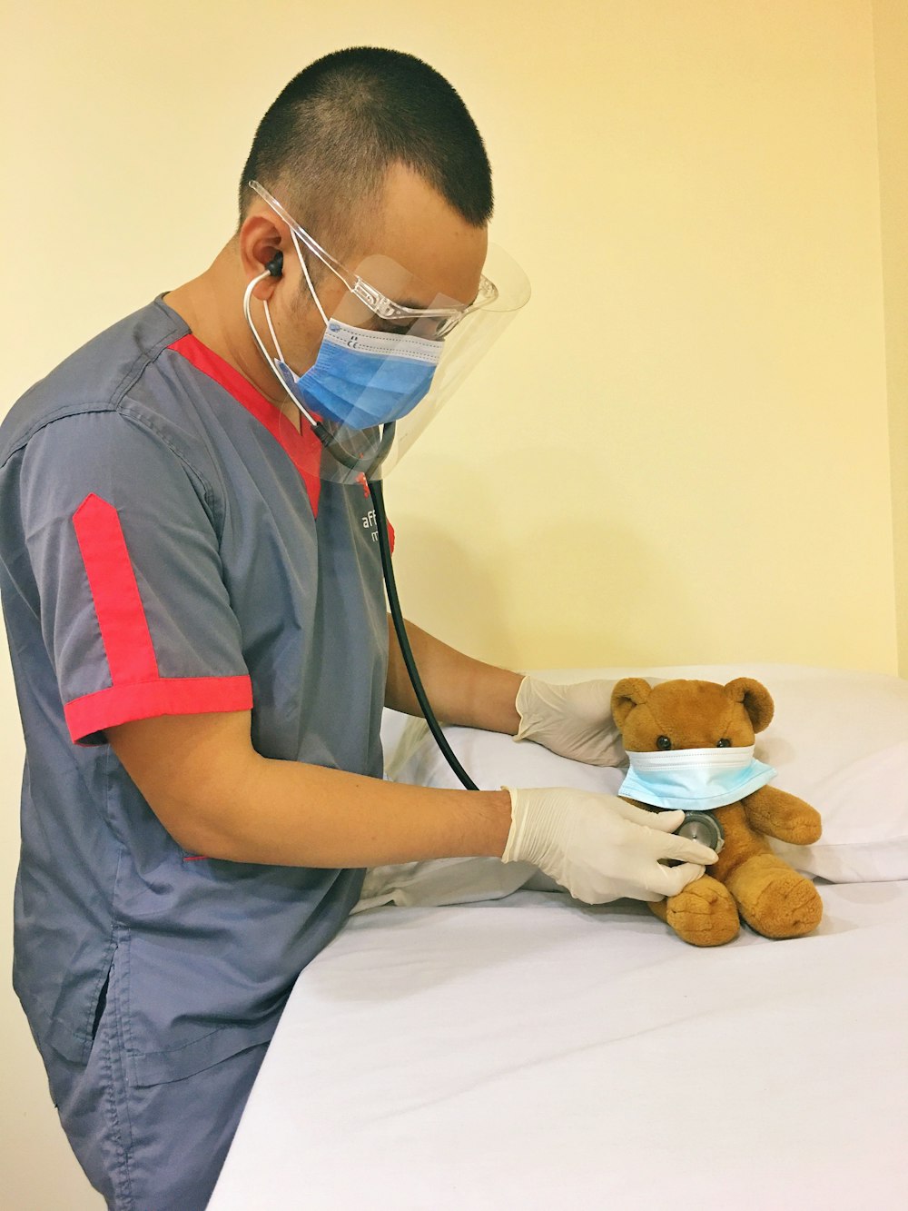 man in blue polo shirt wearing white mask holding brown bread