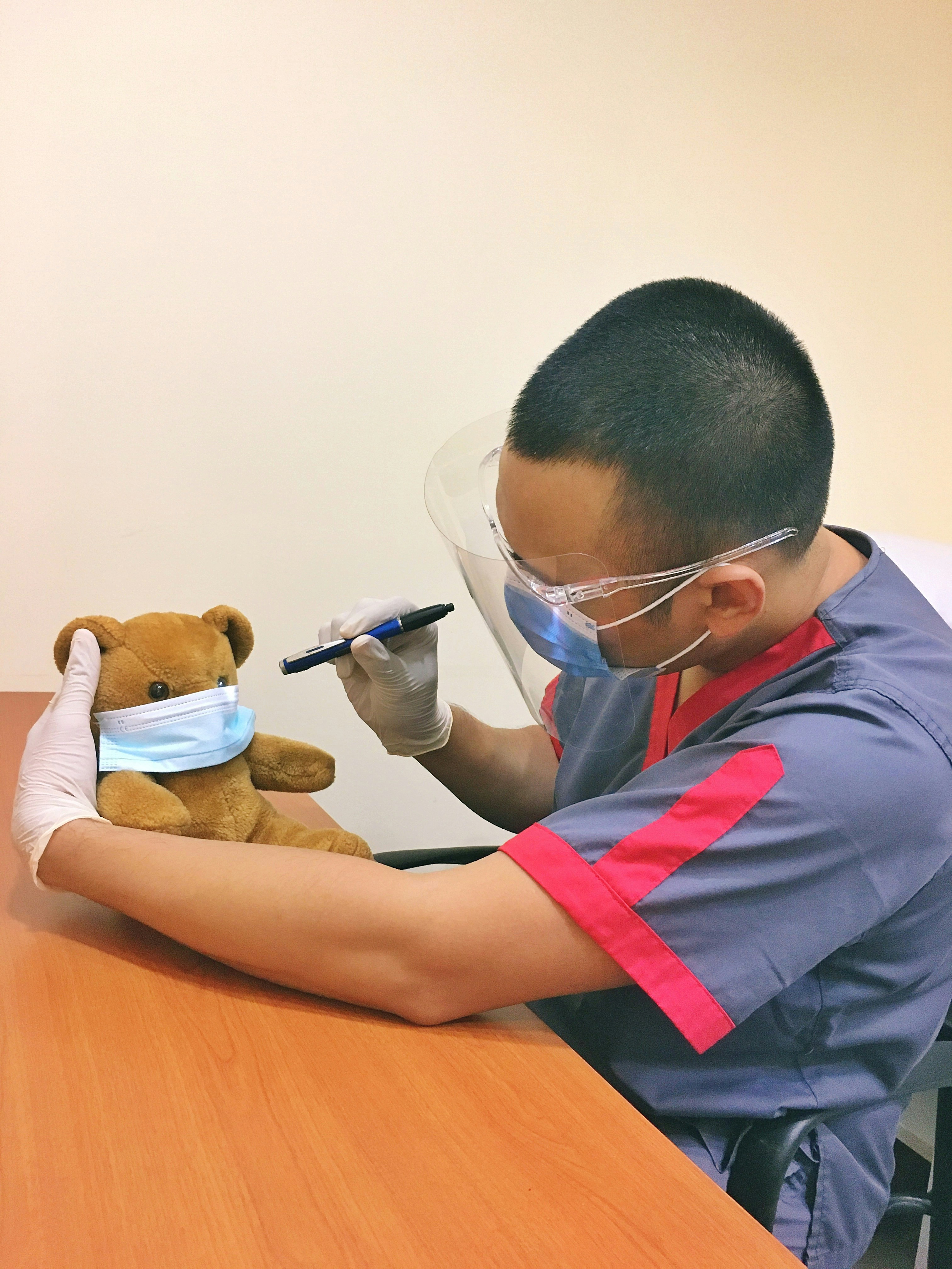 man in blue and red polo shirt wearing blue framed eyeglasses