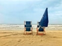 blue and brown wooden chair on beach during daytime