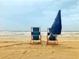 blue and brown wooden chair on beach during daytime