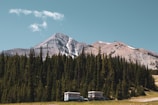 Two full hook-up RV slips nestled among tall trees with mountain views.