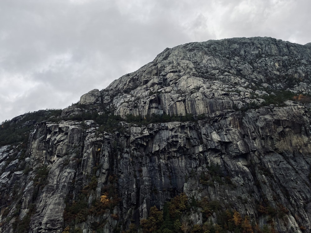 gray rocky mountain under white cloudy sky during daytime