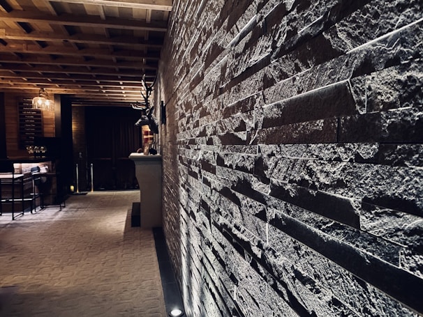 Elegant restaurant interior featuring stone walls and soft, golden lighting.