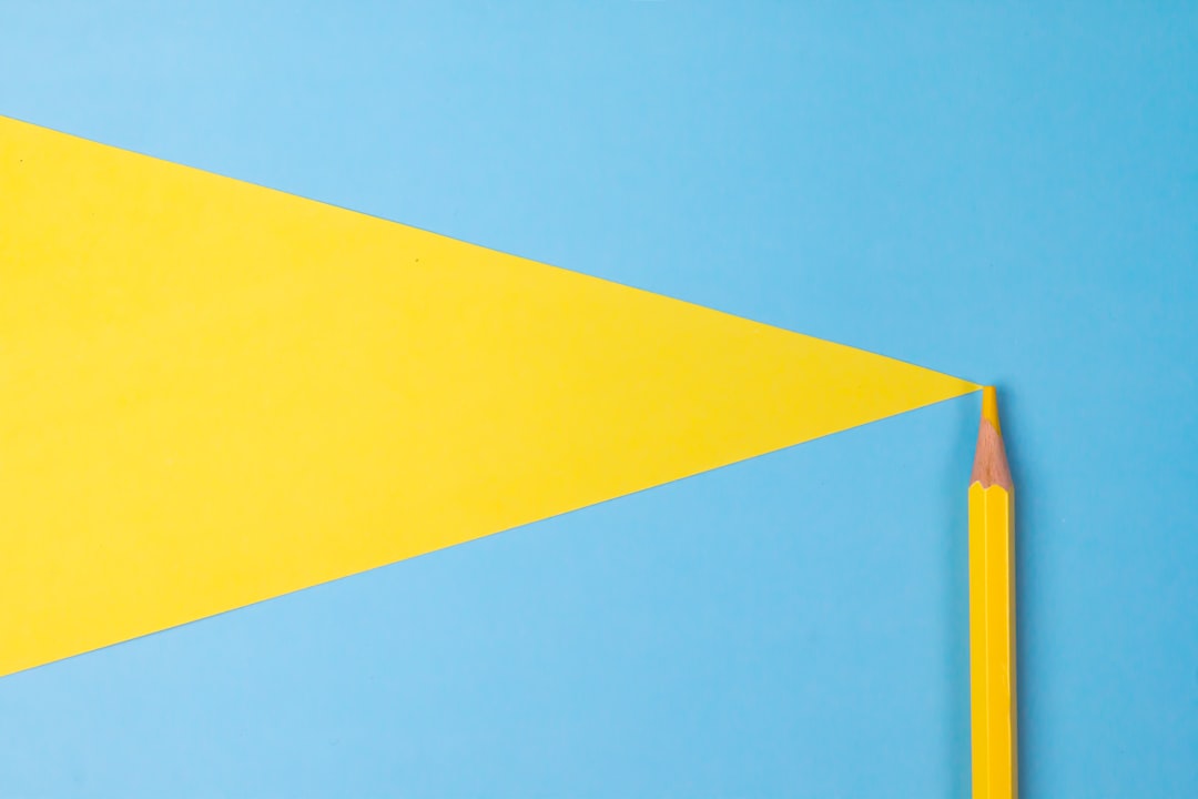 yellow and blue color paper, Yellow color pencil isolated on blue paper background