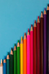 multi colored pencils on pink surface