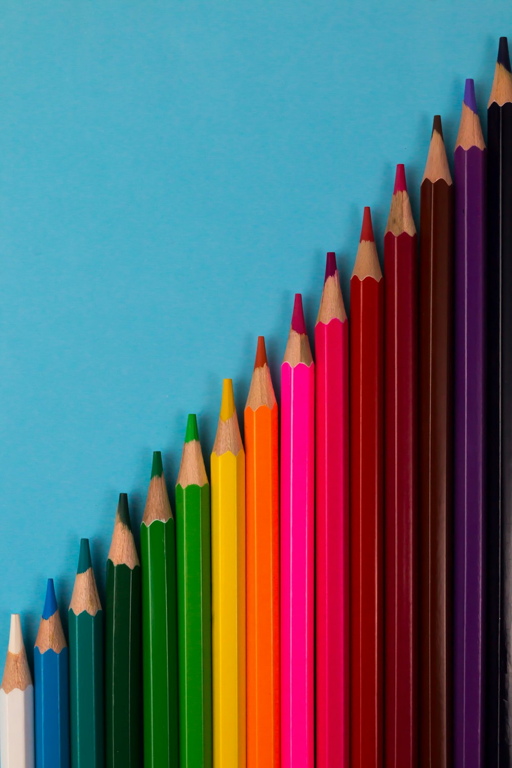 Crayons multi couleurs sur surface rose