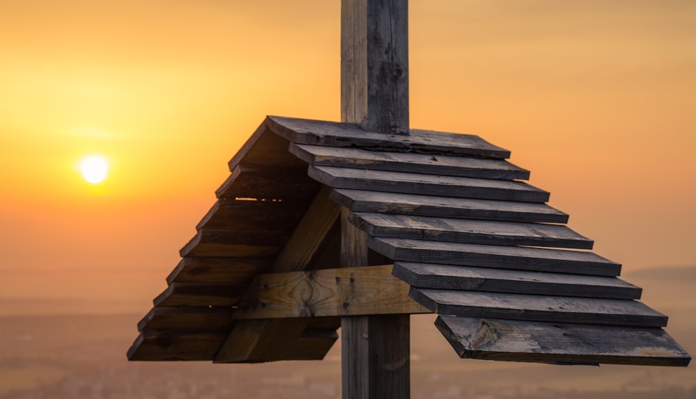 brown wooden house on brown sand during sunset