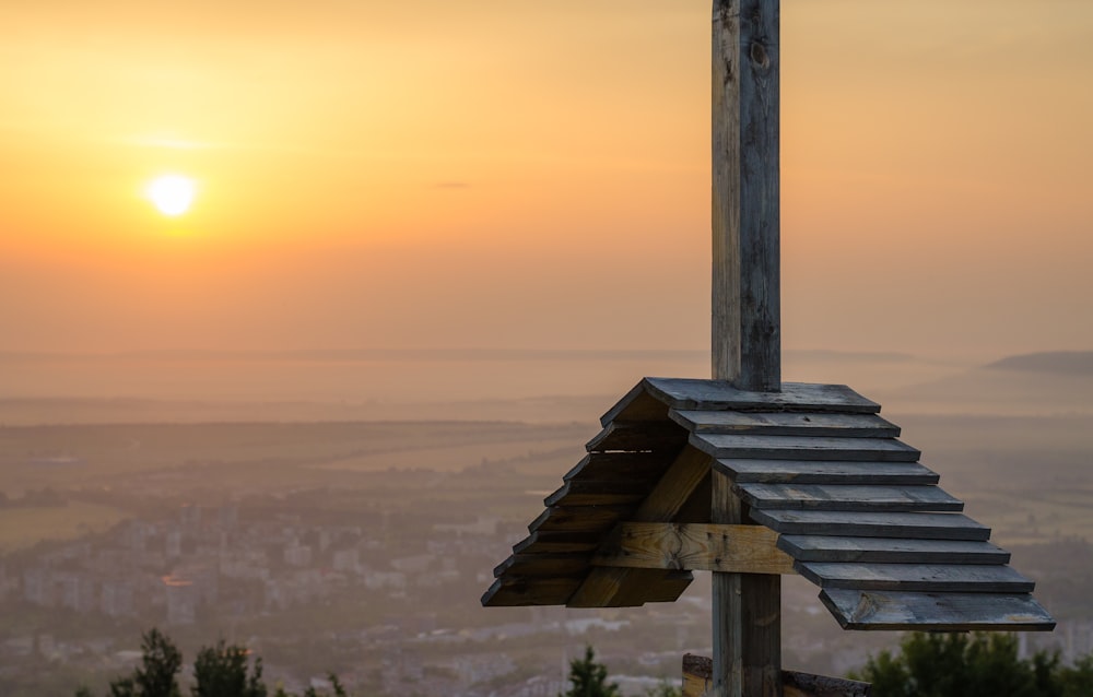 brown wooden house on top of hill during sunset