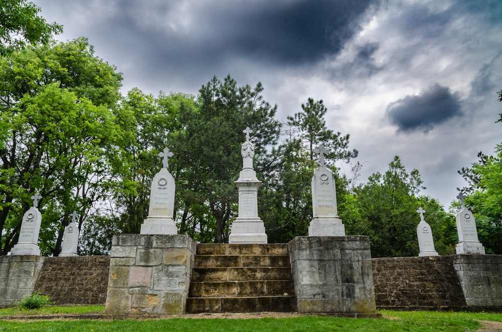 gray concrete cross statue under cloudy sky during daytime