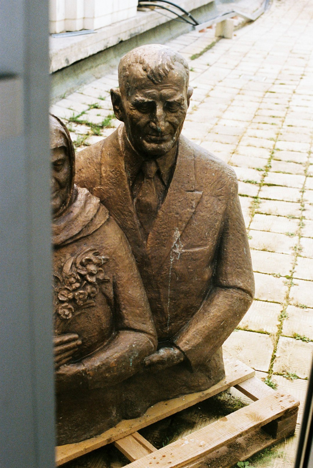man in gray suit jacket statue