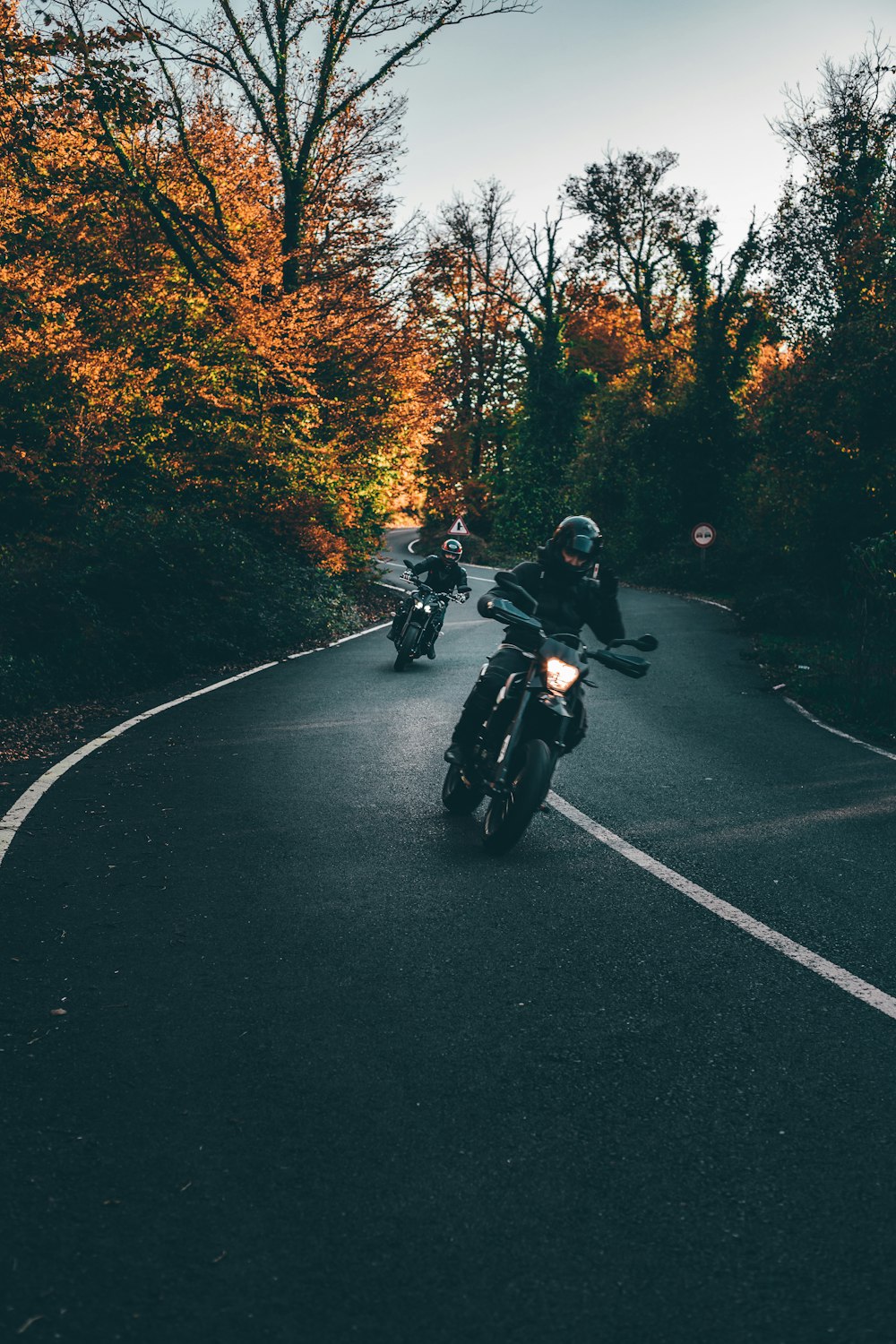 man riding motorcycle on road during daytime