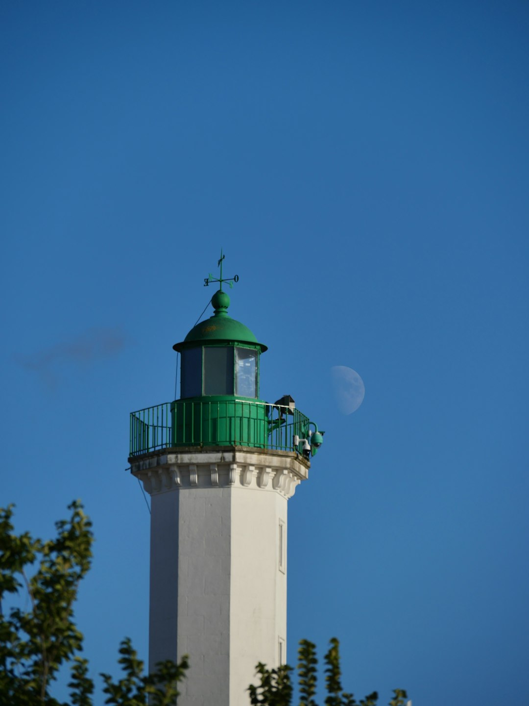 white and green lighthouse under blue sky during daytime