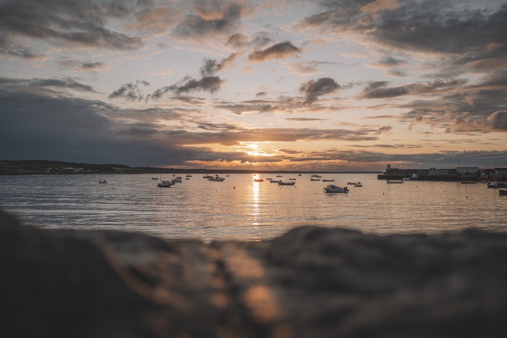 silhouette of boat on sea during sunset