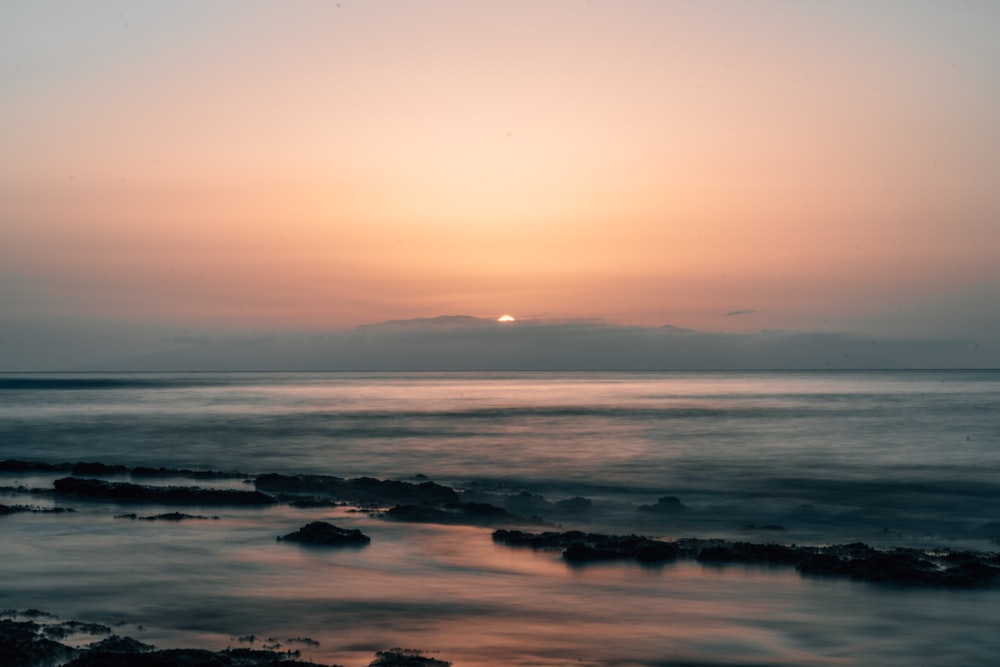 body of water during sunset