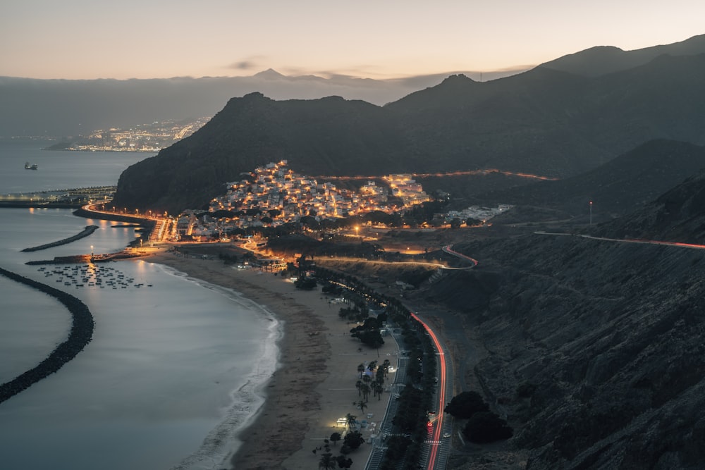 aerial view of city near body of water during night time