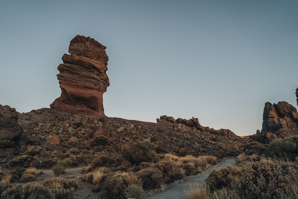 brown rock formation near body of water during daytime