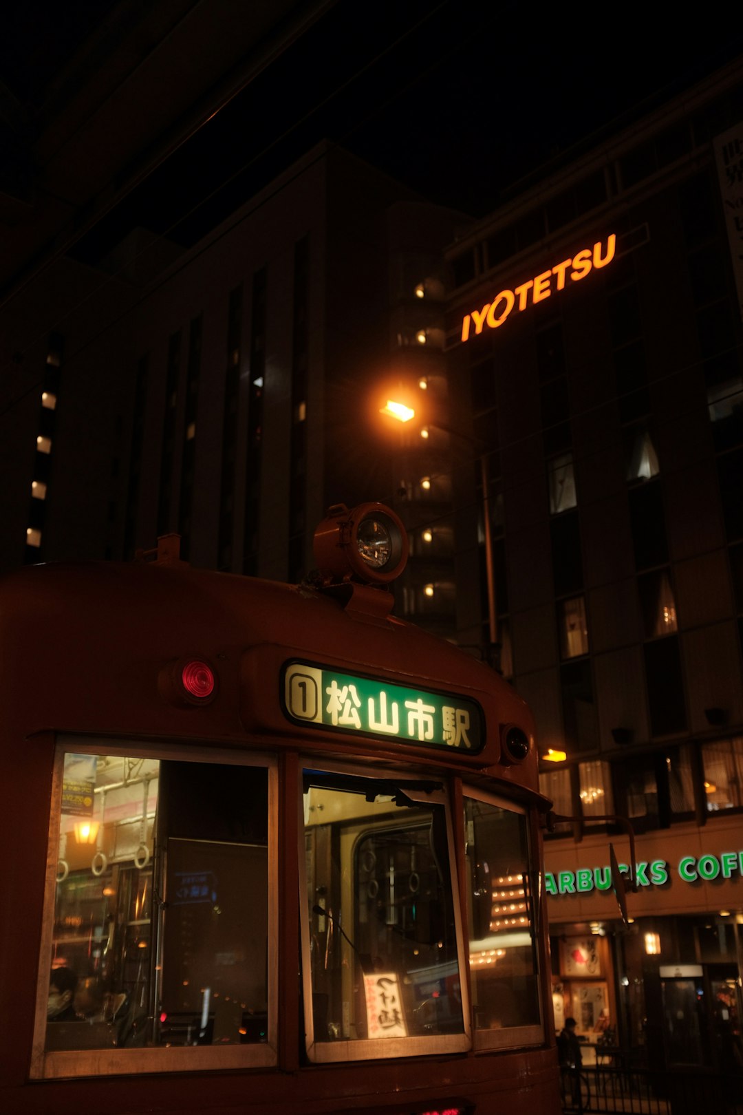 red double decker bus on road during night time