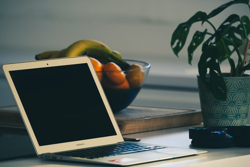 white laptop computer on table