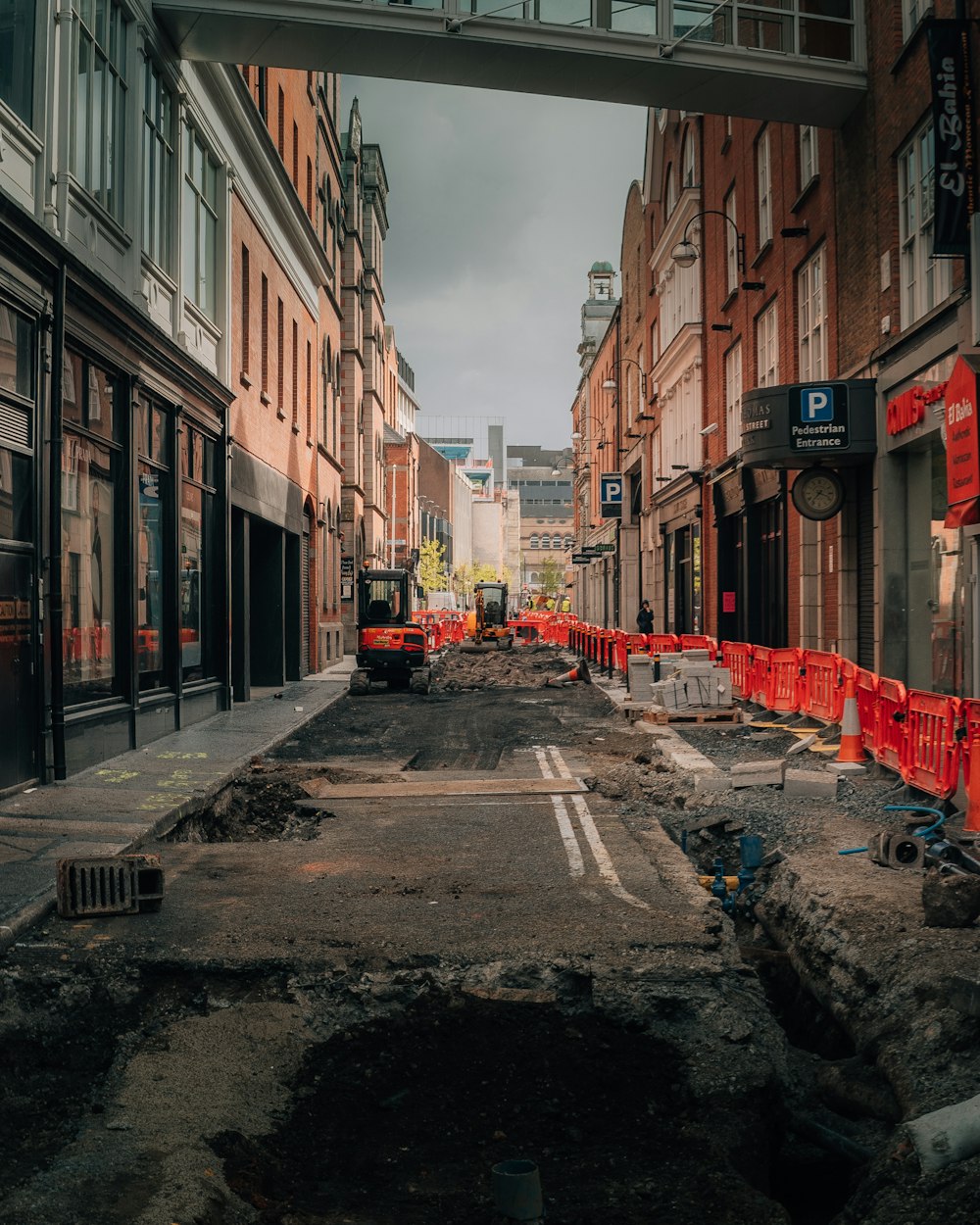 empty street in between of buildings during daytime