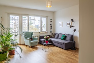 green sofa near glass window