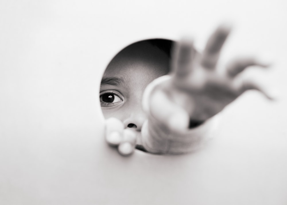 person holding white round ornament