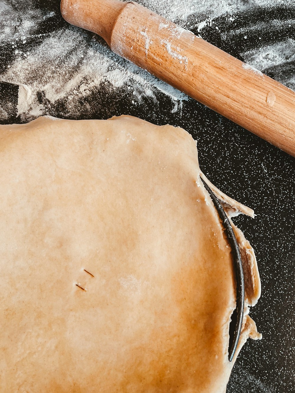 rouleau à pâtisserie en bois brun sur table en bois marron