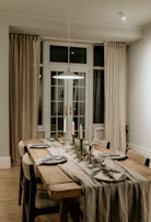 An inviting dining space with warm cream walls and a handcrafted wooden table set for a family meal.