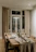 A warmly lit dining room featuring a sleek extendable table set for a family meal.