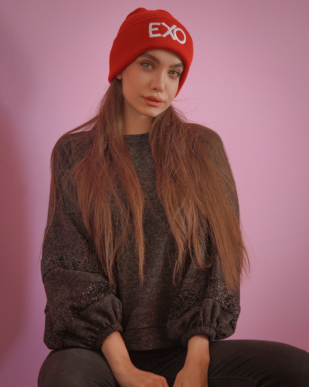 woman in red knit cap and brown sweater