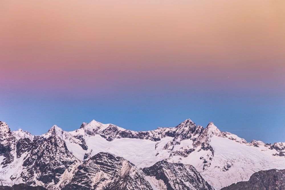 snow covered mountain under blue sky during daytime