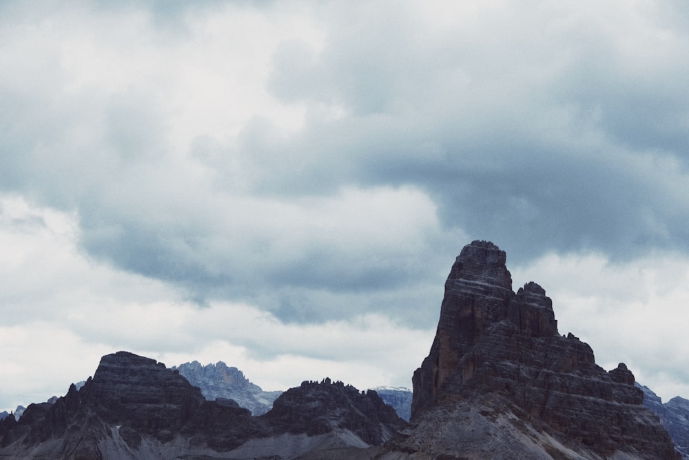 rocky mountain under white clouds during daytime