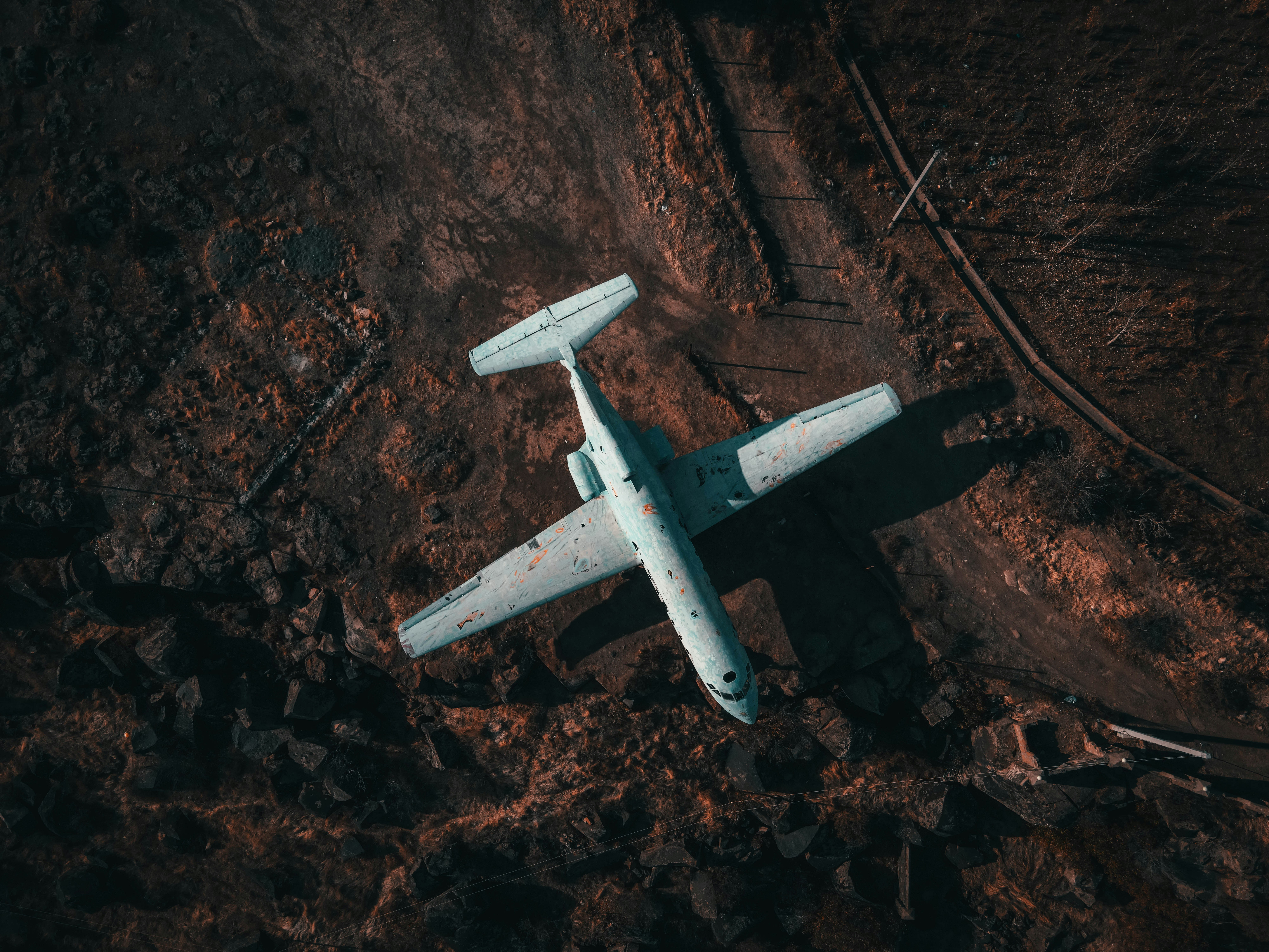 white airplane on brown soil