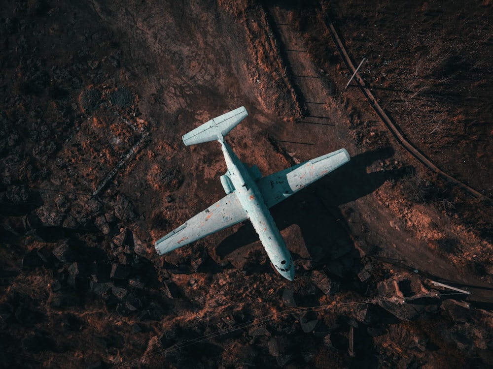 white airplane on brown soil