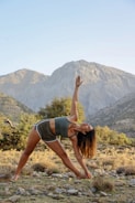woman in black tank top and black shorts raising her hands