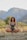 A person meditating in a tranquil garden surrounded by nature.