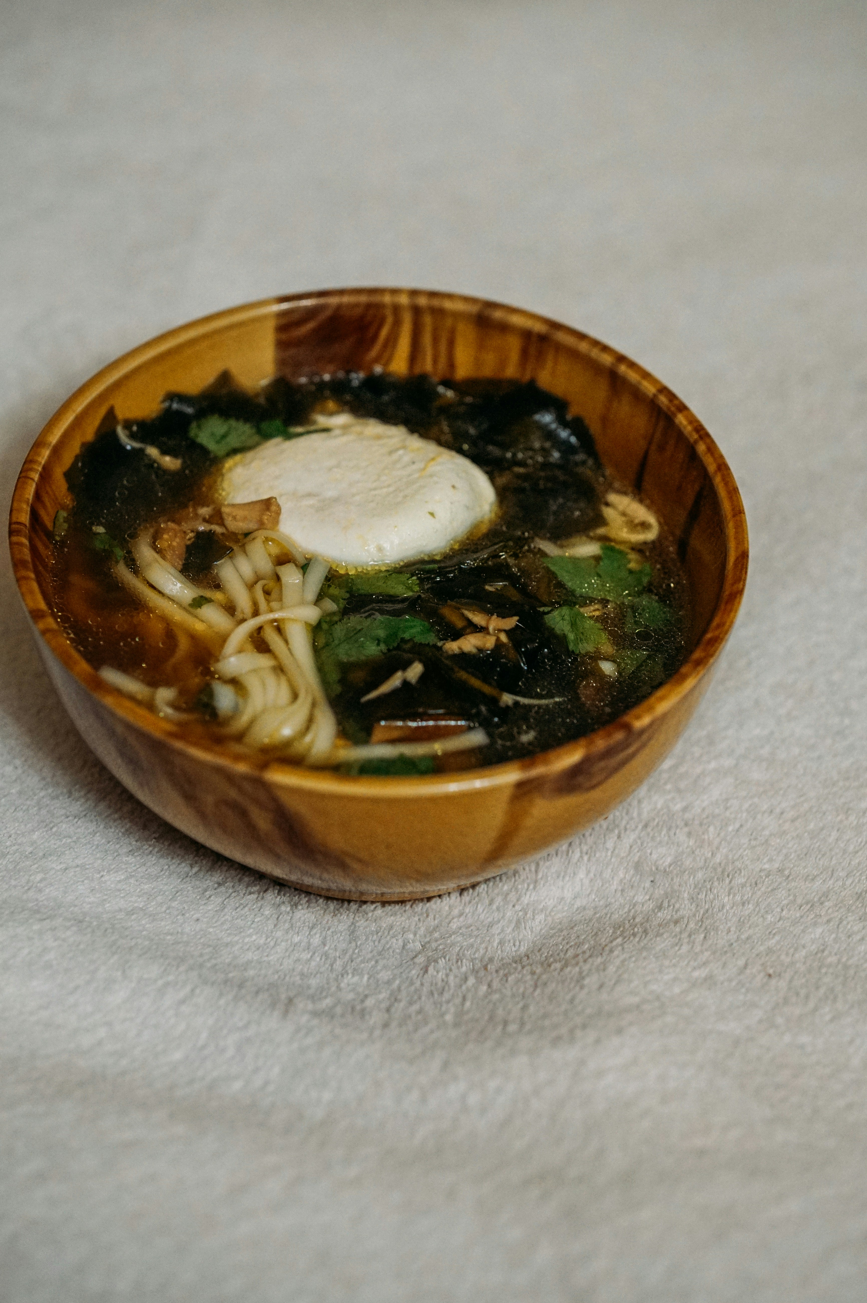 soup with vegetables in brown ceramic bowl