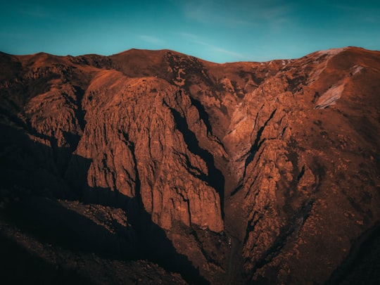 brown rock formation under blue sky during daytime in Arayi Lerr Armenia