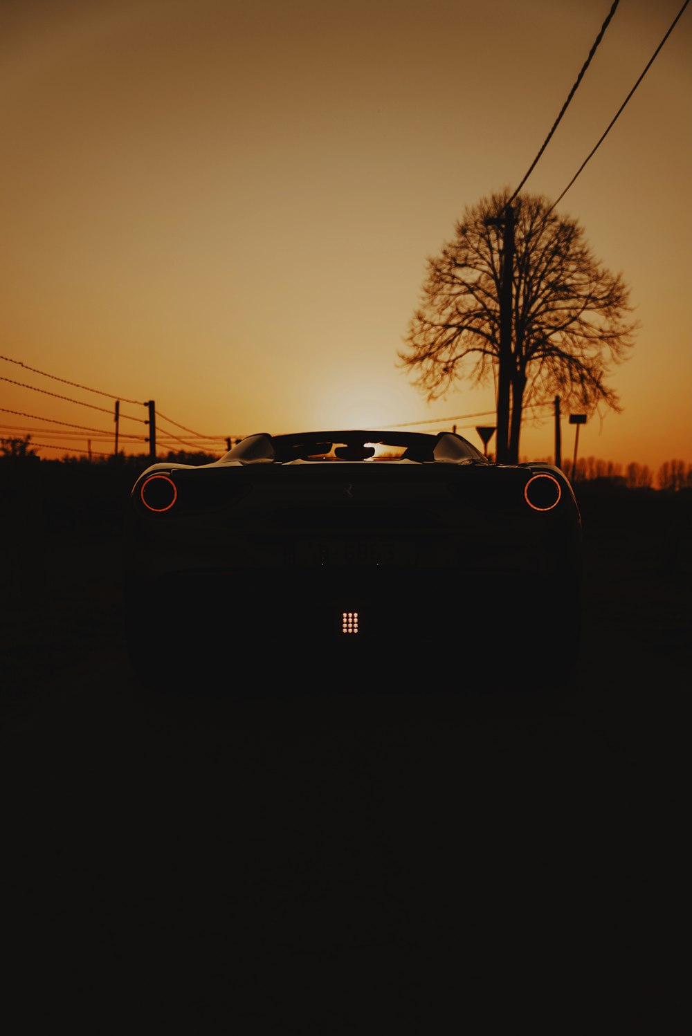 black car on road during sunset