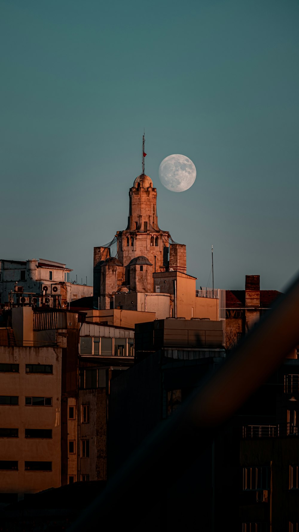 brown concrete building under full moon