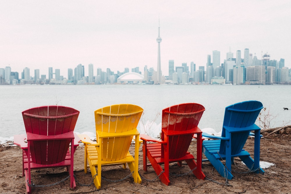 red and brown wooden armchairs on beach during daytime