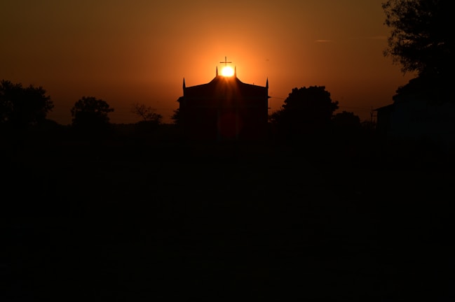 A serene view of the church building at sunset.