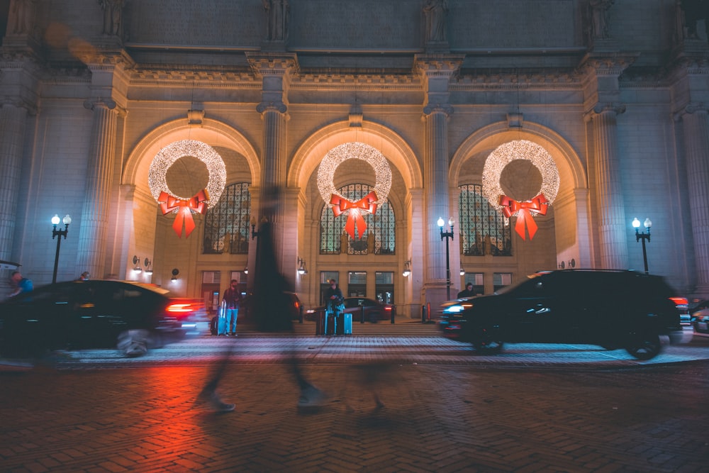 people walking on street near building during night time